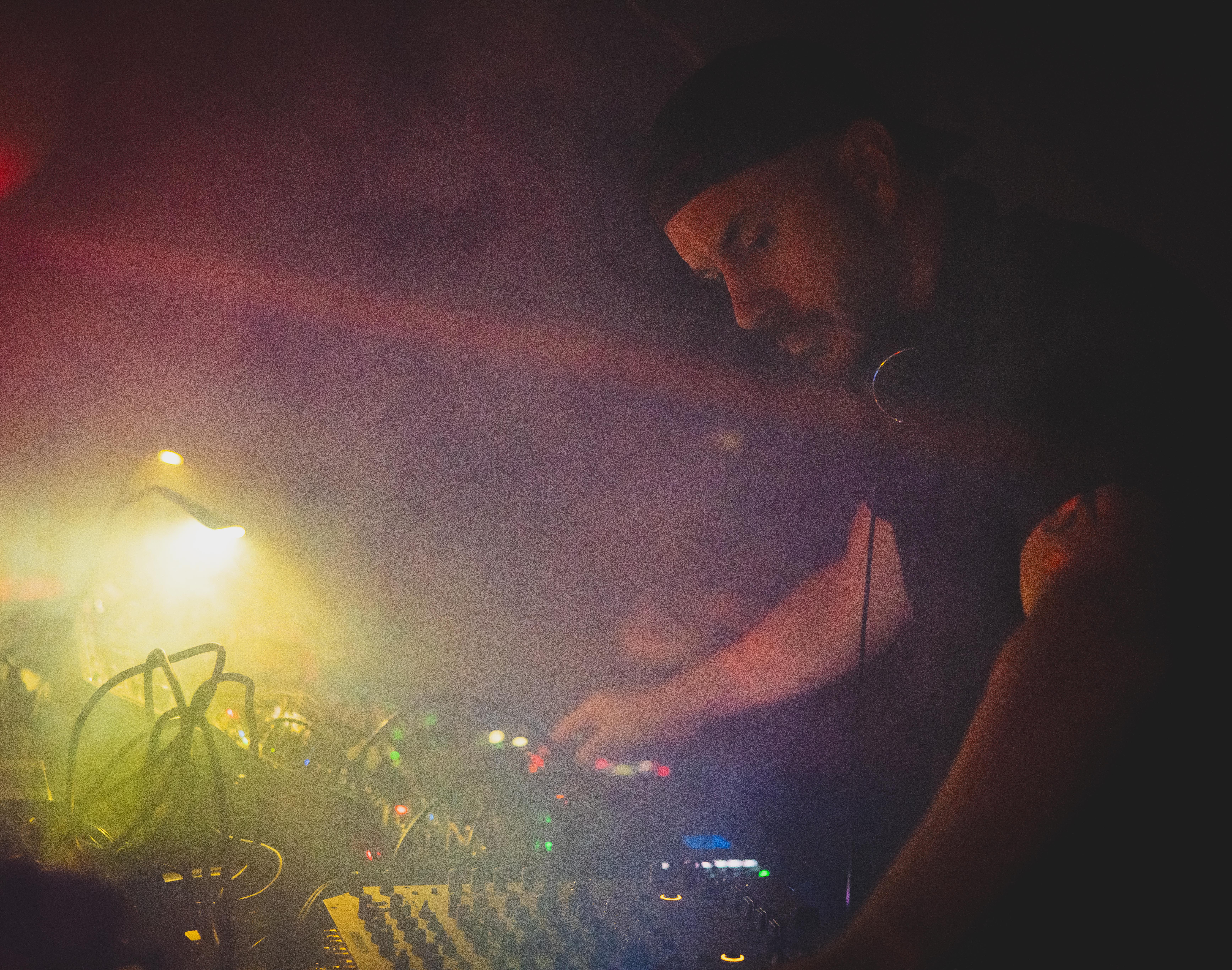 William White at his synthesizers — yellow stage lighting